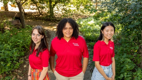 Three students wearing red shirts.