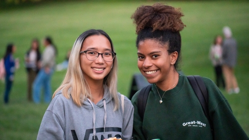 Two students smiling.